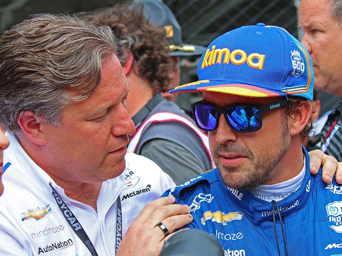 Fernando Alonso (right) talks with McLaren boss Zak Brown Sunday at Indianapolis Motor Speedway. (IndyCar Photo)