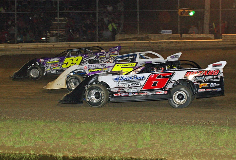 Larry Bellman (59), Blake Spencer (6) and Ray Markham race three-wide during Saturday's World of Outlaws Morton Buildings Late Model Series event at Wayne County Speedway. (Todd Ridgeway Photo)