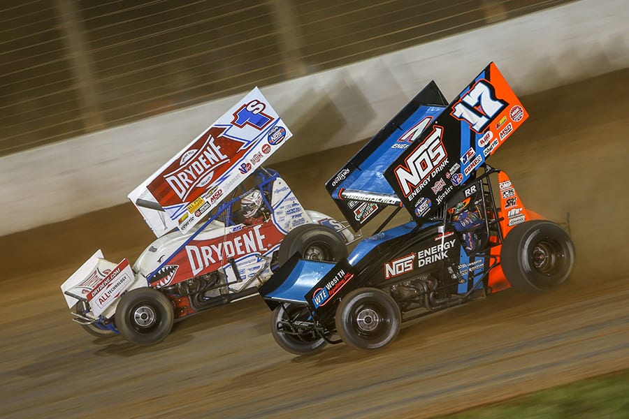 Sheldon Haudenschild (17) races alongside Logan Schuchart during Saturday's World of Outlaws NOS Energy Drink Sprint Car Series feature at The Dirt Track at Charlotte. (Adam Fenwick Photo)