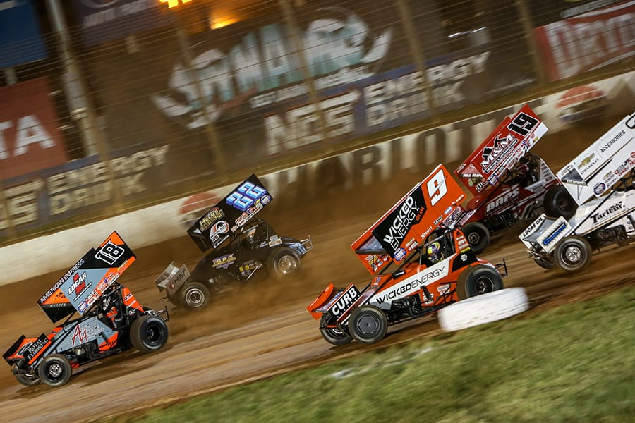 Ian Madsen (18) leads a pack of cars during Friday's World of Outlaws NOS Energy Drink Sprint Car Series event at The Dirt Track at Charlotte. (Adam Fenwick Photo)