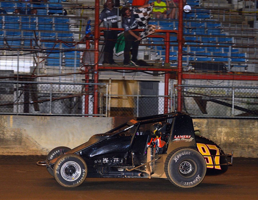 Tyler Courtney takes the checkered flag to win the Hoosier Hundred Thursday at the Indiana State Fairgrounds. (Dave Heithaus Photo)