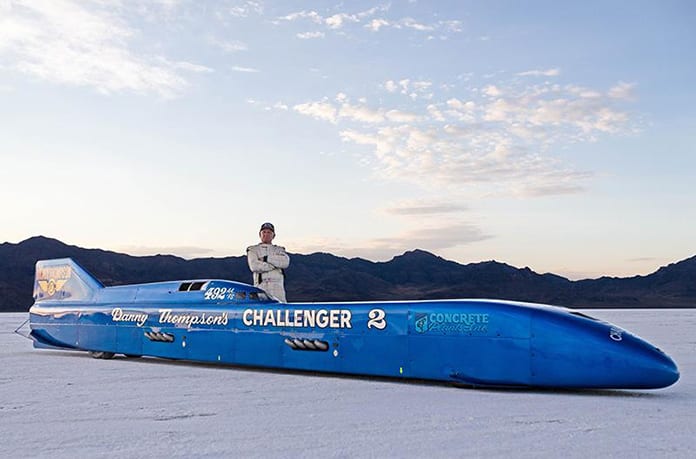 Danny Thompson posing beside his Challenger II land speed car.