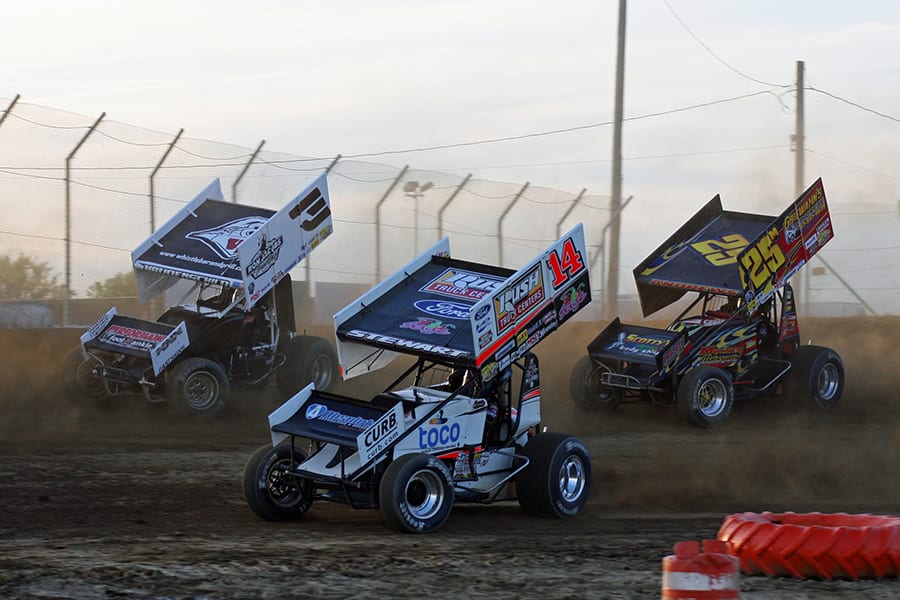 Tony Stewart (14), Jac Haudenschild (3) and Chris Andrews battle for position during Saturday's Ollie's Bargain Outlet All Star Circuit of Champions event at Attica Raceway Park. (Todd Ridgeway Photo)