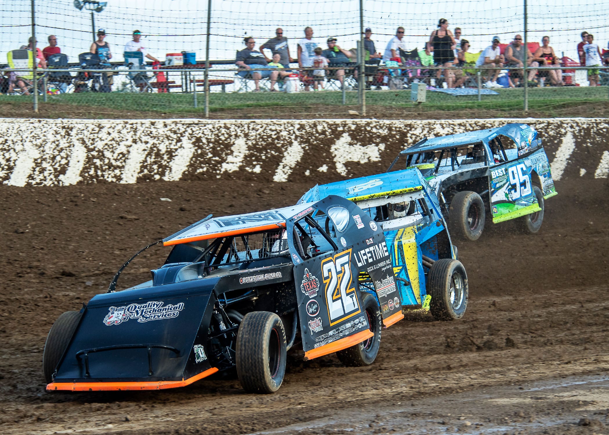 Tony Anderson(22), Ryan Sutter(18) and Jerry Bowersock race hard in their modified heat race at Limaland. (Mike Campbell photo)