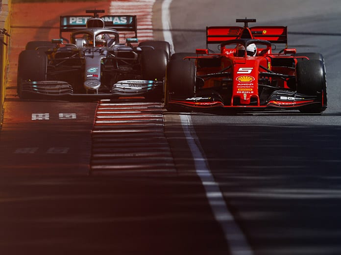 Sebastian Vettel (5) comes back on the track in front of Lewis Hamilton, a move that ultimately cost Vettel Sunday's Canadian Grand Prix. (Mercedes Photo)