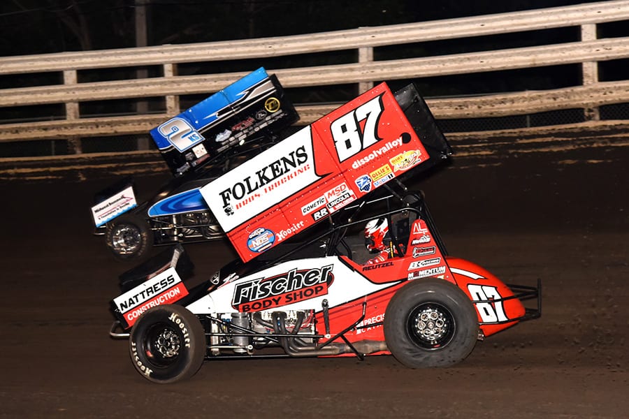 Aaron Reutzel (87) chases Austin McCarl during Monday's Front Row Challenge at Southern Iowa Speedway. (Paul Arch Photo)