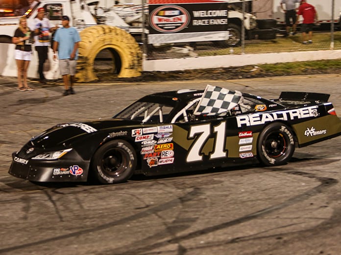 Ryan Repko celebrates with the checkered flag after winning Saturday night at Hickory Motor Speedway. (Adam Fenwick Photo)