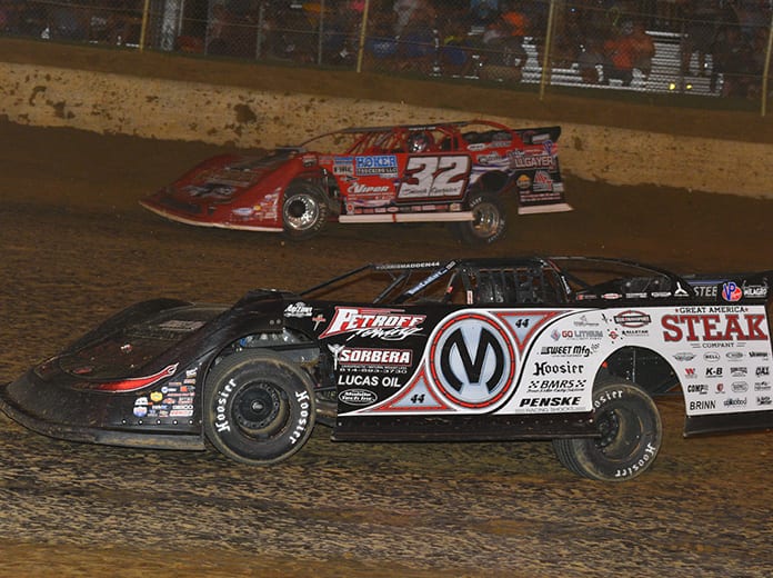 Chris Madden (0m) races under Bobby Pierce during Saturday's North/South 100 at Florence Speedway. (Michael Moats Photo)
