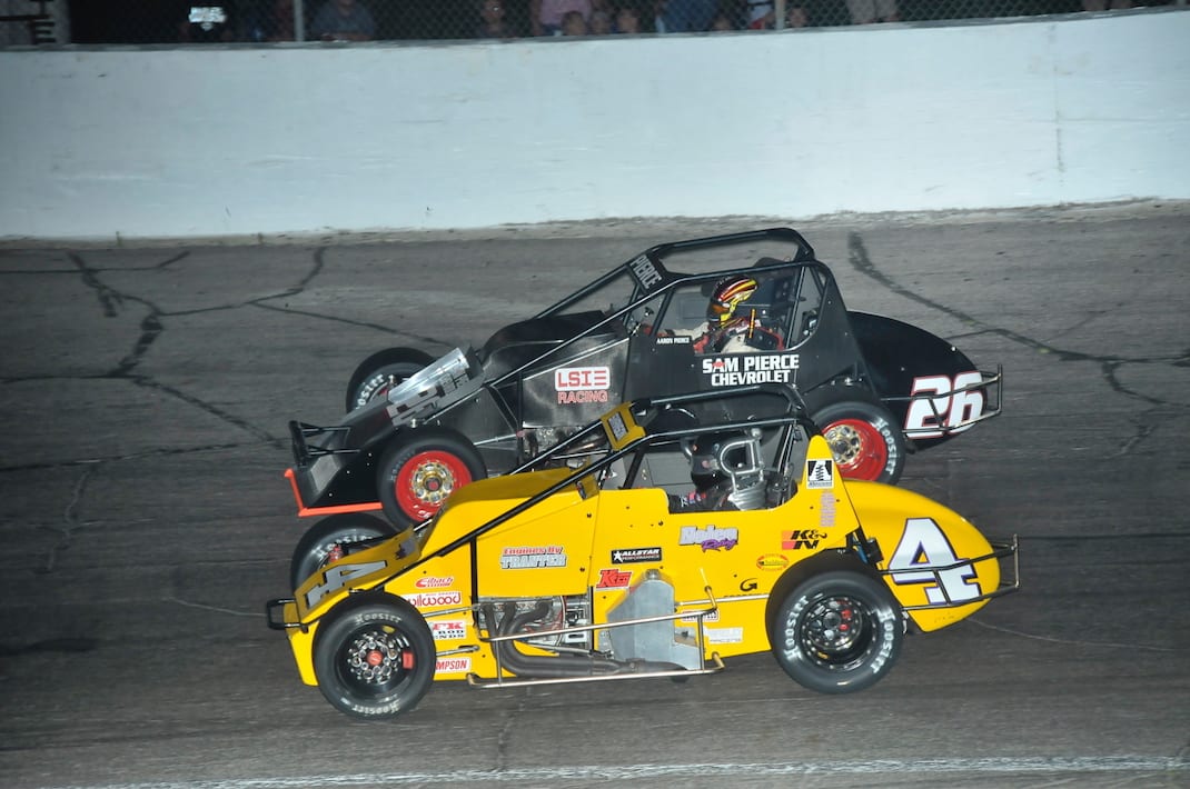 Kody Swanson (4) races under Aaron Pierce at Anderson (Ind.) Speedway. (Randy Crist photo)