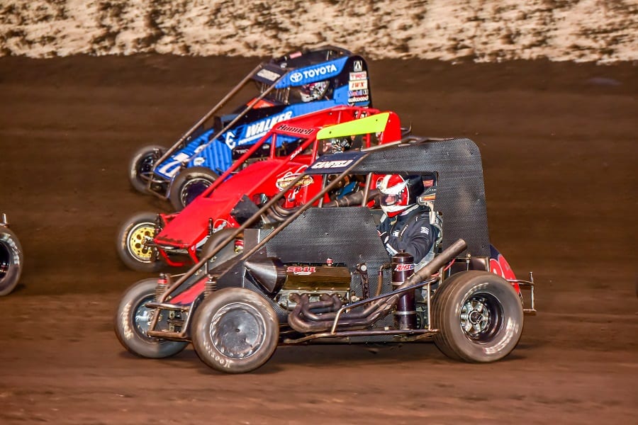 Dalton Camfield (86), Broc Hunnell (103) and Tanner Carrick go three-wide in Saturday's POWRi National Midget League feature at Macon Speedway. (Mark Coffman photo)
