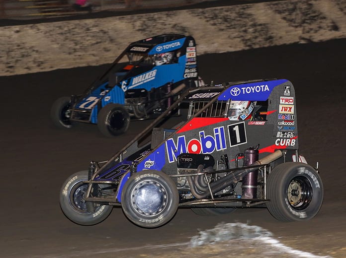 Logan Seavey (67) races past Tanner Carrick en route to victory Saturday at Macon Speedway. (Brendon Bauman Photo)
