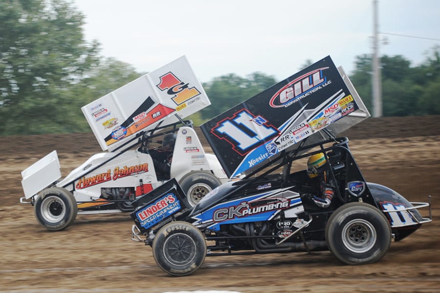 Buddy Kofoid (11) races under Tim Shaffer during preliminary action for Saturday's Brad Doty Classic finale at Attica Raceway Park. (Julia Johnson Photo)