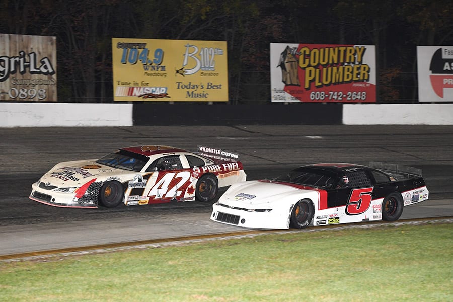 Travis Sauter (5) races to the inside of Dennis Prunty during the Falloween 150 Saturday at Dells Raceway Park. (Doug Hornickel Photo)