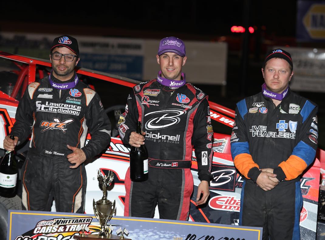 Mat Williamson (center) is joined on the podium by Erick Rudolph (right) and Mike Maresca. (DIRTcar photo)