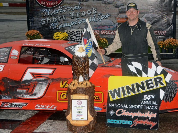 Casey Johnson stands in victory lane after being declared the winner of the National Short Track Championship on Saturday at Rockford Speedway. (Stan Kalwasinski Photo)