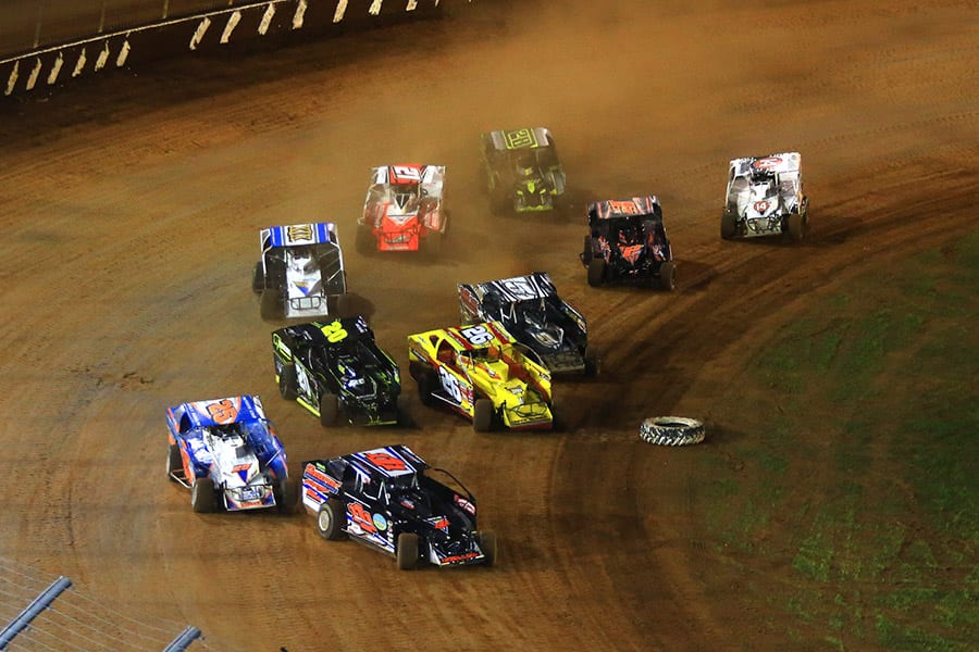 The stars of the Super DIRTcar Series battle for position during a heat race Friday at The Dirt Track at Charlotte as part of the Can-Am World Finals. (HHP/Jim Fluharty Photo)