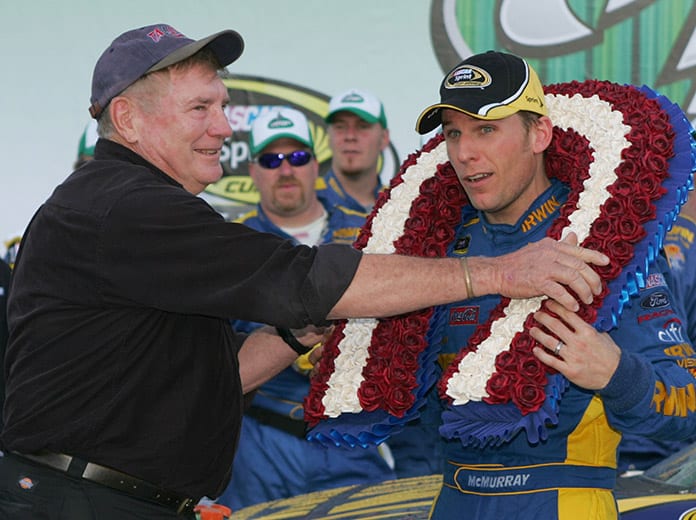 Richard Brickhouse (left) puts a wreath over the head of 2009 Talladega Speedway race winner Jamie McMurray. (NASCAR Photo)