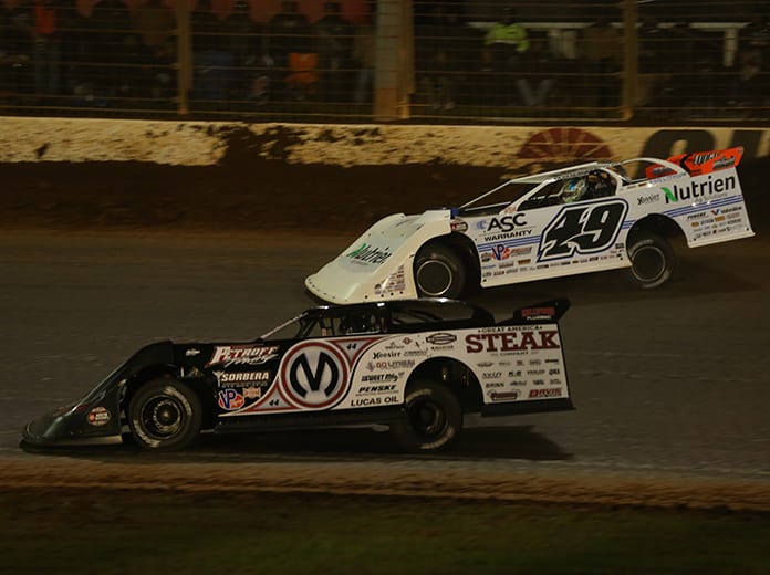 Chris Madden (0M) races under Jonathan Davenport during Friday's World of Outlaws Morton Buildings Late Model Series feature at The Dirt Track at Charlotte. (Dallas Breeze Photo)
