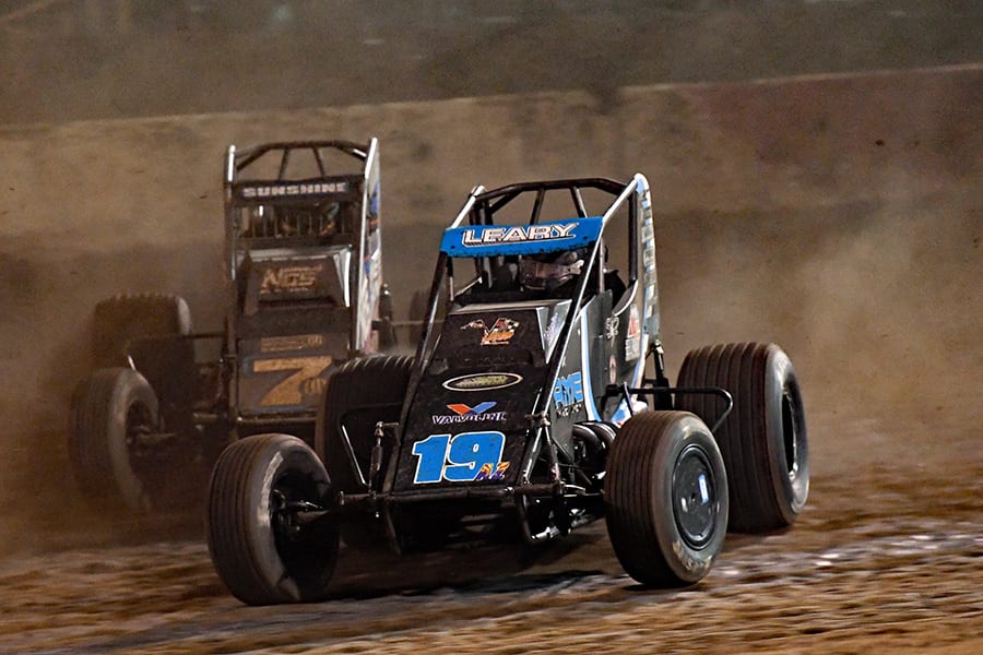 C.J. Leary (19) races ahead of Tyler Courtney during Saturday's Oval Nationals finale at Perris Auto Speedway. (Steve Himelstein Photo)