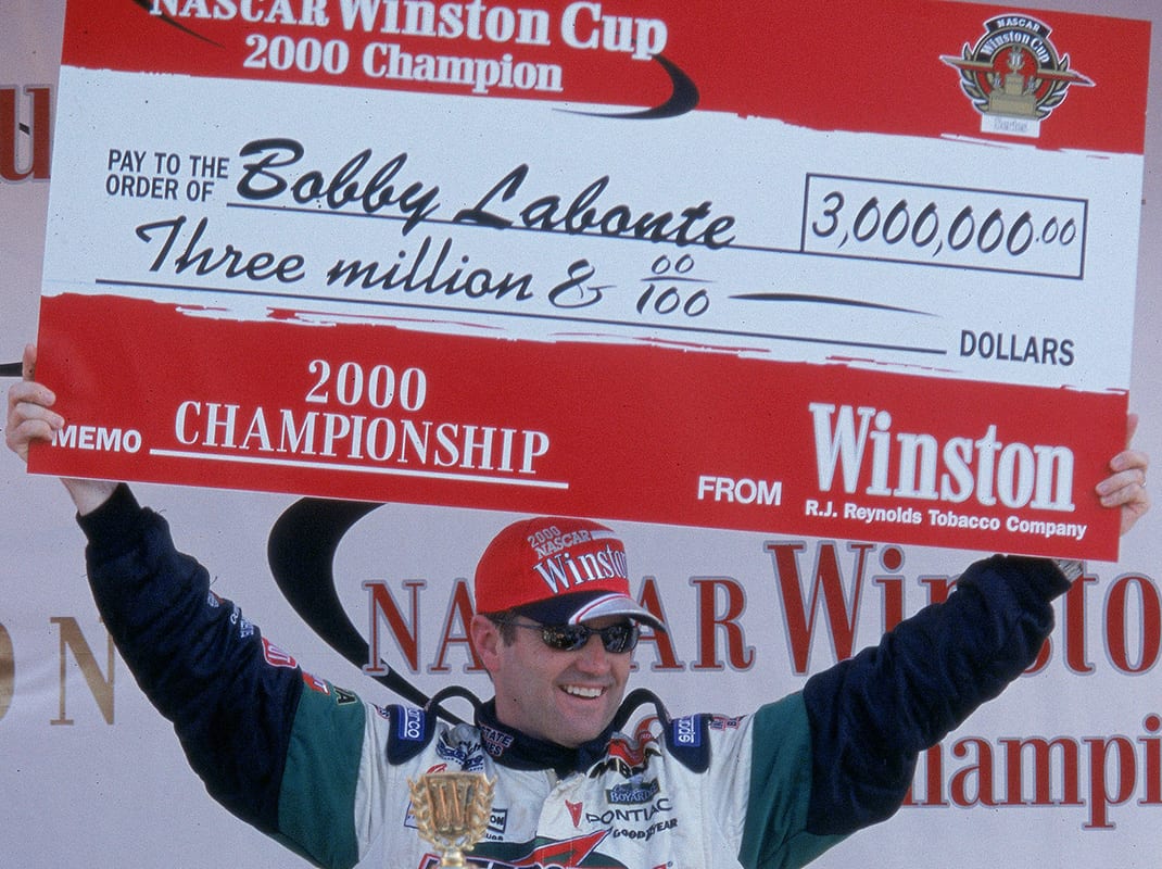 12 Nov 2000: Driver Bobby Labonte #18 poses with his winning check after winning the Pennzoil 400, part of the NASCAR Winston Cup Series at the Homestead Miami Speedway in Homestead, Florida.Mandatory Credit: Jon Ferrey /Allsport