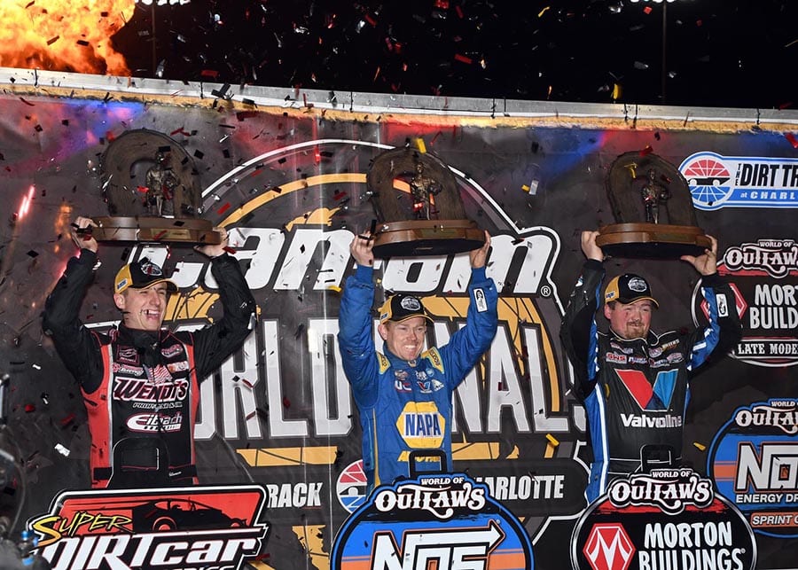 (From left) Mat Williamson, Brad Sweet and Brandon Sheppard celebrate after clinching their respective championships Saturday at The Dirt Track at Charlotte. (Frank Smith Photo)
