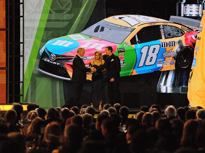 Kyle Busch receives his Monster Energy NASCAR Cup Series championship ring from NASCAR's Jim France during Thursday's NASCAR Cup Series Awards event in Nashville, Tenn. (Dave Moulthrop Photo)