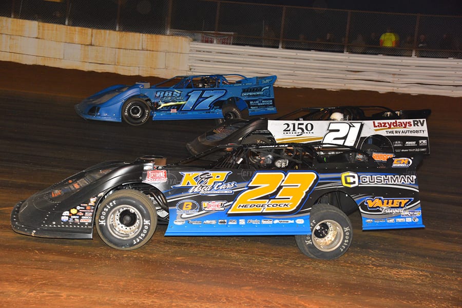Cory Hedgecock (23), Robby Moses (21) and Logan Roberson race three-wide during Saturday's Drydene Xtreme DIRTcar Series event at Volunteer Speedway. (Michael Moats Photo)