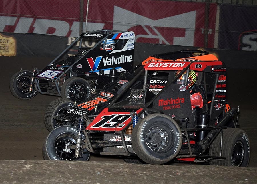 Spencer Bayston (19), Jason McDougal (76) and C.J. Leary race three-wide during Thursday's Chili Bowl preliminary feature at Tulsa Expo Raceway. (Frank Smith Photo)