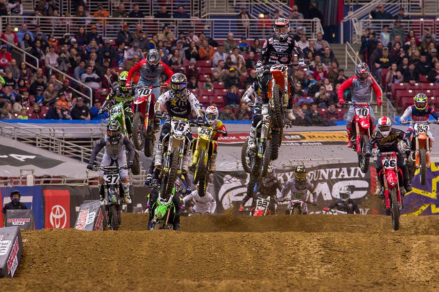 Riders battle for position as they go over jumps during Saturday's Supercross event in St. Louis, Mo. (Darren Rutmanis Photo)