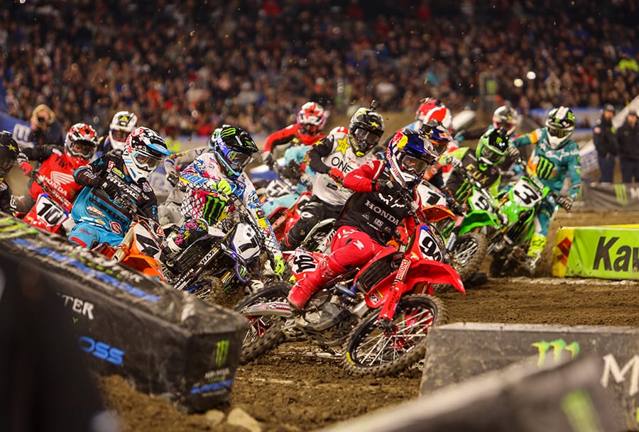 Ken Roczen (94) leads a hungry pack of 450 class riders through the opening corners of Saturday's Monster Energy AMA Supercross event in Anaheim, Calif. (Mark Munoz Photo)