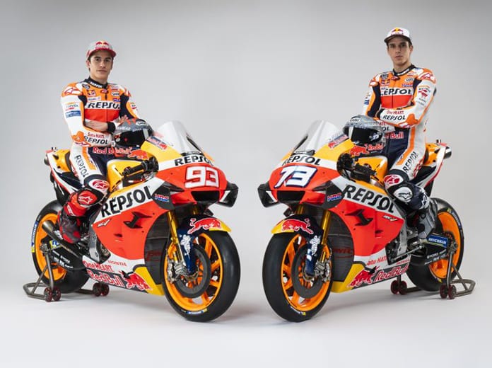 Brothers Marc and Alex Marquez sit aboard their Repsol Honda bikes.