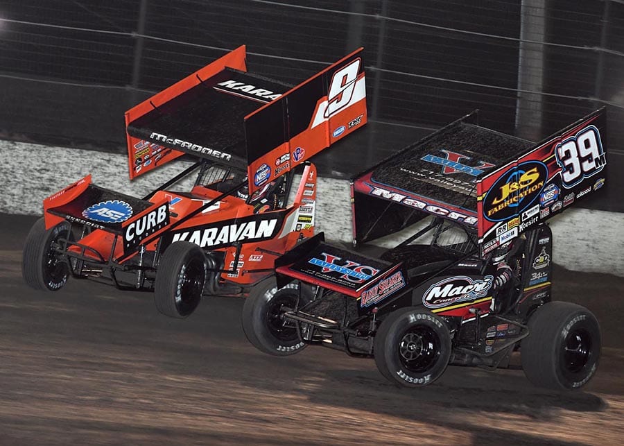 James McFadden (9) races around the outside of Anthony Macri during Friday's World of Outlaws NOS Energy Drink Sprint Car Series opener at Volusia Speedway Park. (Frank Smith Photo)