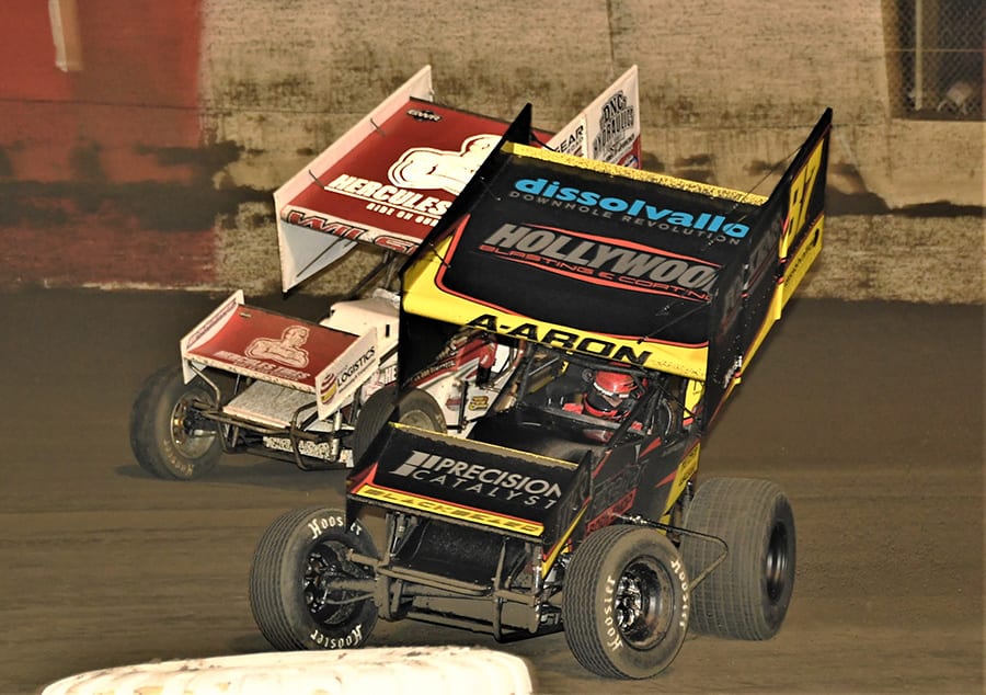 Aaron Reutzel (87) leads Greg Wilson during Monday's Ollie's Bargain Outlet All Star Circuit of Champions main event at East Bay Raceway Park. (Al Steinberg Photo)