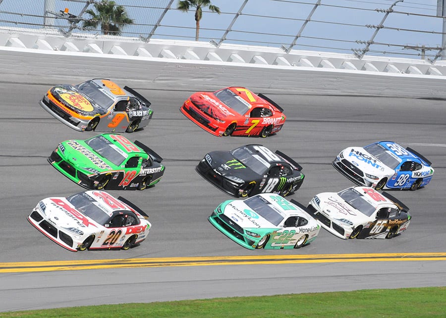 Harrison Burton (20), Brandon Jones (19) and Noah Gragson (9) race three-wide at the front of the field during Saturday's NASCAR Xfinity Series race at Daytona Int'l Speedway. (Dave Moulthrop Photo)