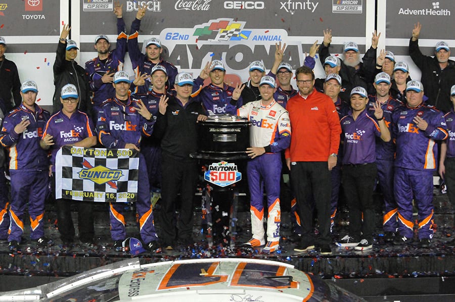 Denny Hamlin poses in victory lane with his team after winning the Daytona 500. (Dave Moulthrop Photo)