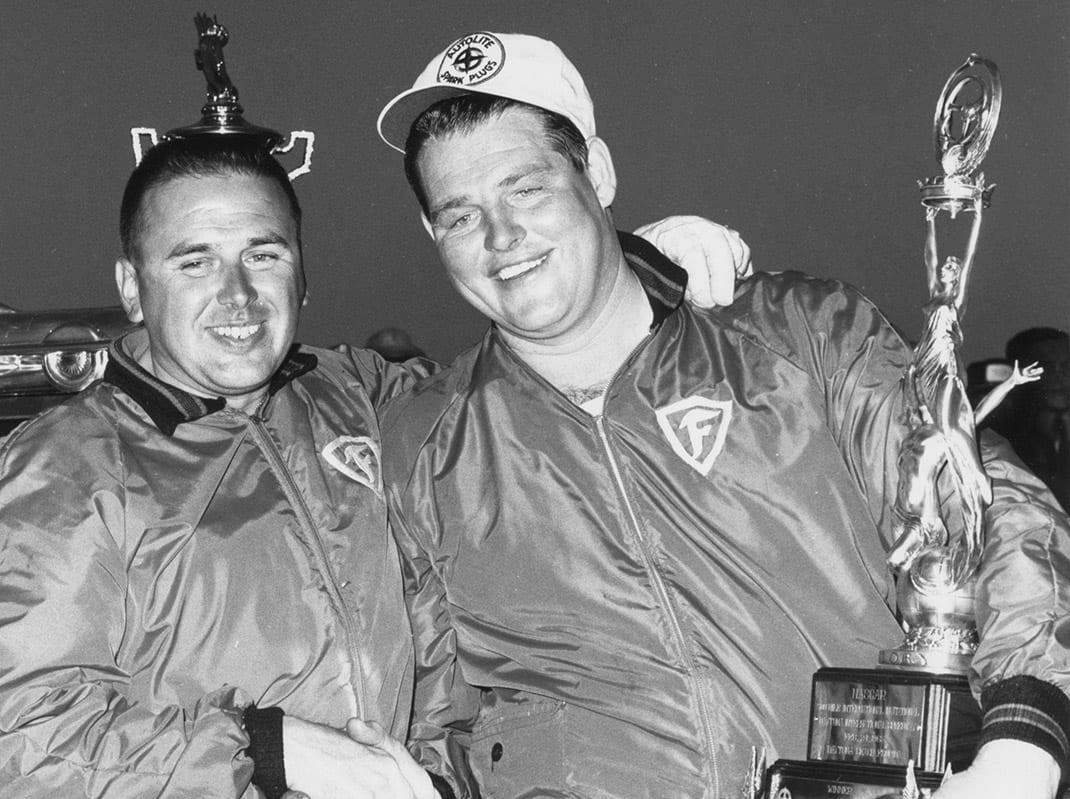 DAYTONA BEACH, FL - FEBRUARY 24, 1963: Tiny Lund (right) was a last-minute substitute for the Wood Brothers team after their regular driver Marvin Panch was injured in an earlier crash. In storybook fashion, Lund took the race and became a much-loved figure in early NASCAR racing. (Photo by RacingOne/Getty Images)