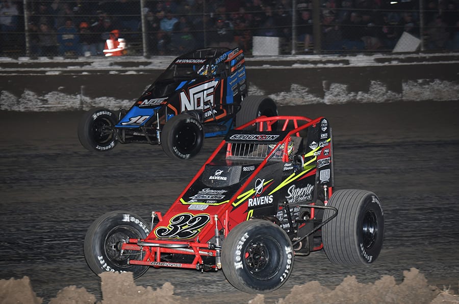 Chase Stockon (32) races under Chris Windom during Saturday's USAC AMSOIL National Sprint Car Series event at Bubba Raceway Park. (Max Dolder Photo)