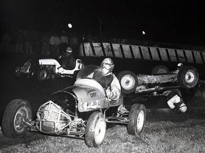 During his championship, Eddie Russo was involved in a high-speed flip at Raceway Park in early August of 1950. Rex Easton and Bud Koehler (77) try to stay out of the crash.