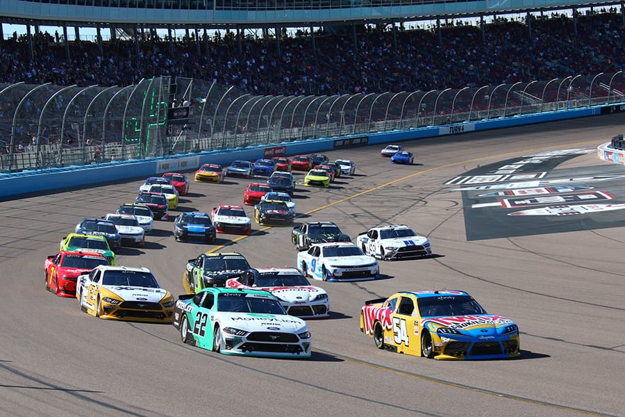Kyle Busch (54) and Austin Cindric (22) lead the way at the start of Saturday's NASCAR Xfinity Series race at Phoenix Raceway. (Ivan Veldhuizen Photo)