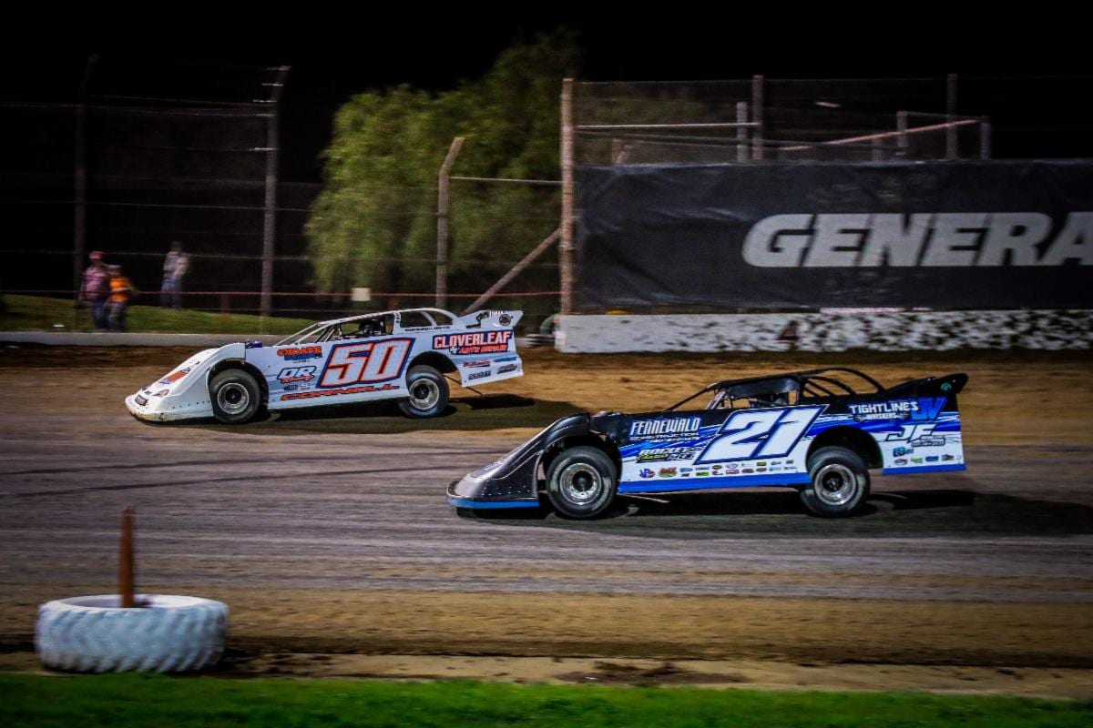 Three-time defending track champ Johnny Fennewald (21) closes in on Kaeden Cornell in the final laps Saturday night at Lucas Oil Speedway. (GS Stanek Racing Photography)
