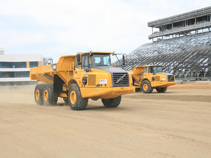 Jeg Coughlin Jr. and Mike Neff raced earthmovers during a press event prior to the opening of zMAX Dragway.