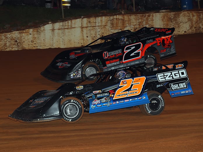 Cory Hedgecock (23) races under Nick Hoffman on Monday night at 411 Motor Speedway. (Chad Wells Photo)