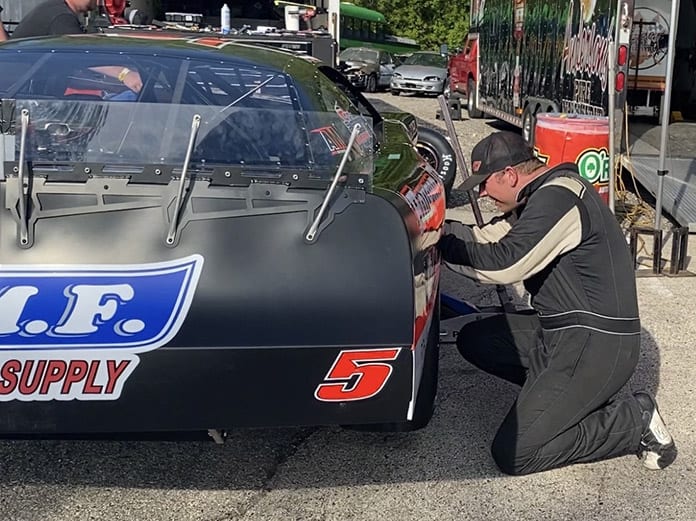 Casey Johnson works on his race car in the pits Sunday afternoon at Slinger Super Speedway. (Nick Dettmann Photo)