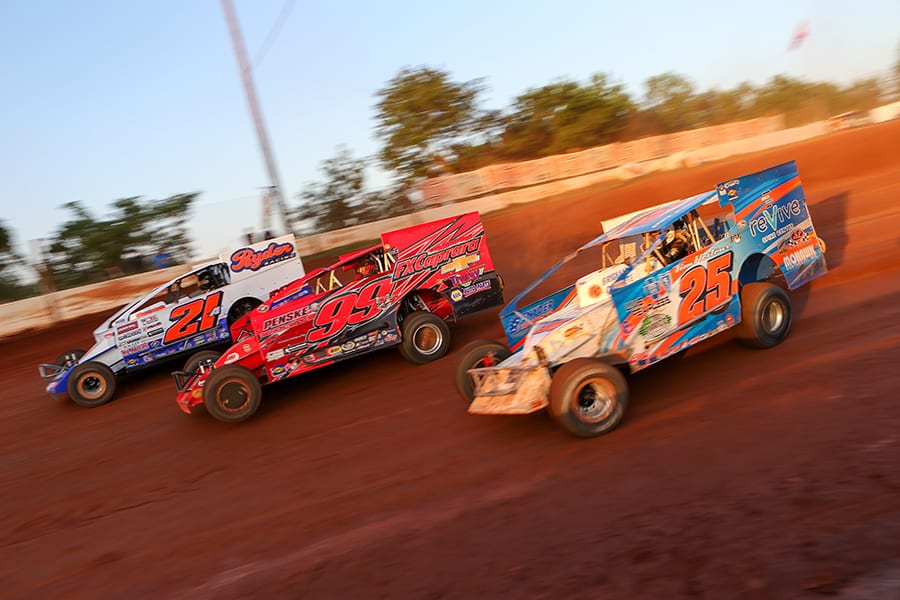 Peter Britten (21a), Larry Wight (99) and Erick Rudolph race three-wide during Short Track Super Series preliminary action on Saturday at Cherokee Speedway. (Adam Fenwick Photo)