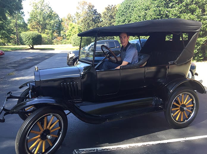 Joey Logano sits aboard his vintage Model T Ford
