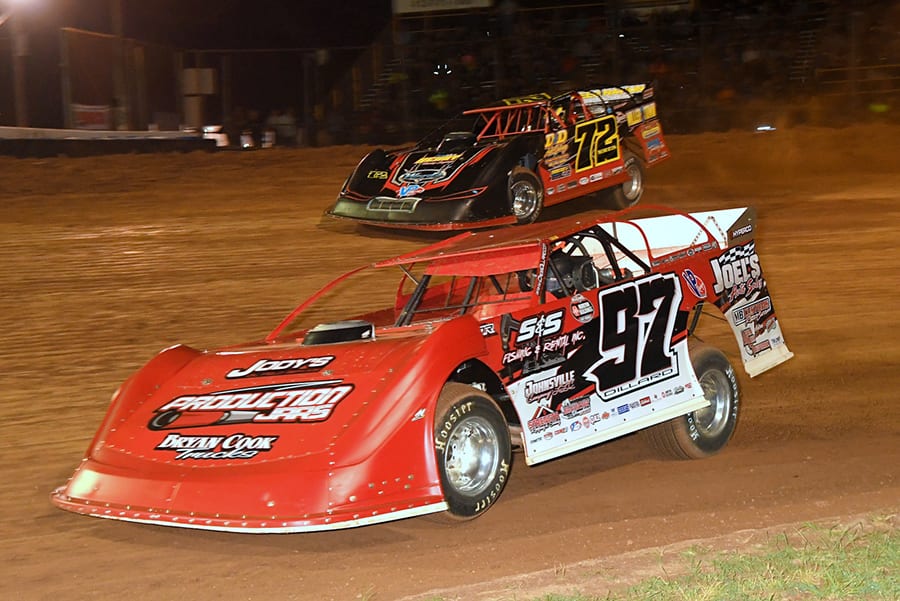 Cade Dillard (97) battles alongside Mike Norris during Thursday's Firecracker 100 preliminary event at Lernerville Speedway. (Hein Brothers Photo)