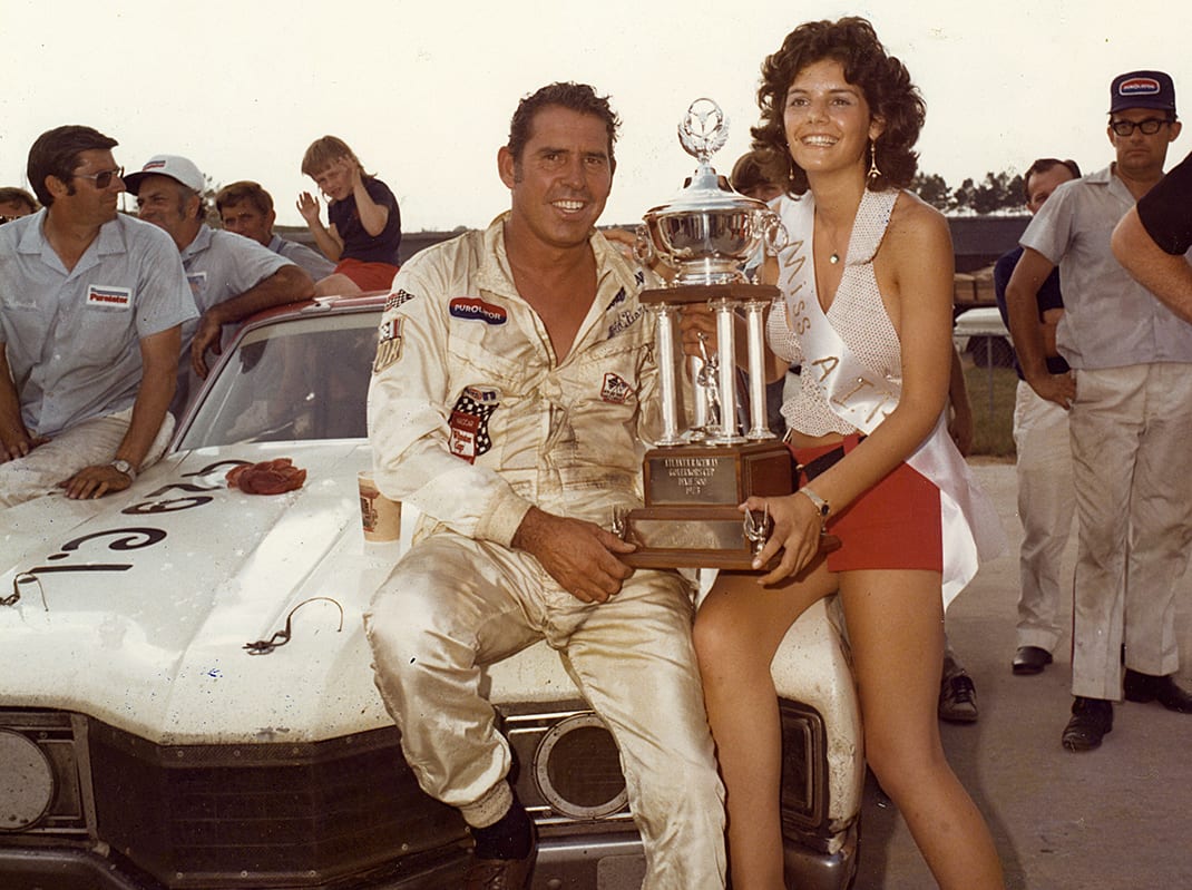 HAMPTON, GA ? July 22, 1973: David Pearson is joined my Miss Atlanta International Raceway in victory lane after Pearson came home victorious in the Dixie 500 NASCAR Cup race, giving him a sweep of the two Cup races held at Atlanta during the year. Pearson was virtually unbeatable during the Cup season, winning 11 of the 18 races he and his Wood Brothers team entered. (Photo by ISC Images & Archives via Getty Images)