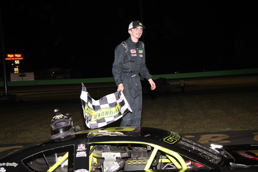 An exhausted Marcel J. Gravel of Wolcott climbs out of his car after winning the Maplewood/Irving Oil Late Model feature on opening night. (Alan Ward photo)