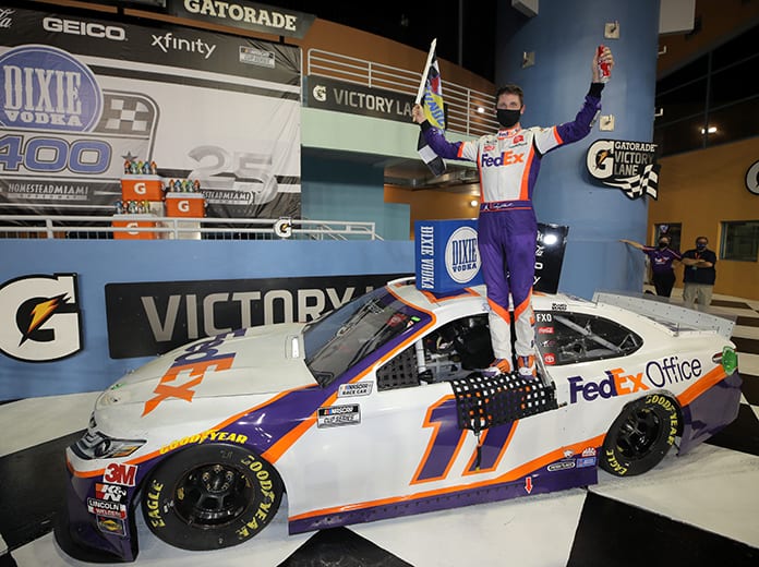 Denny Hamlin poses in victory lane after winning Sunday's Dixie Vodka 400 at Homestead-Miami Speedway. (Chris Graythen/Getty Images Photo)