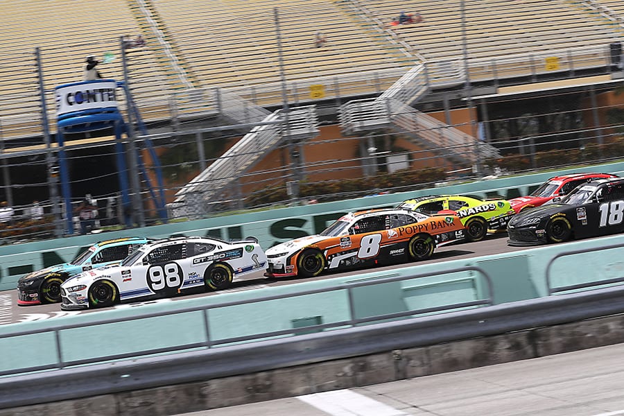 Chase Briscoe (98) and Noah Gragson (9) lead the NASCAR Xfinity Series field during a late-race restart Sunday at Homestead-Miami Speedway. (NASCAR Photo)